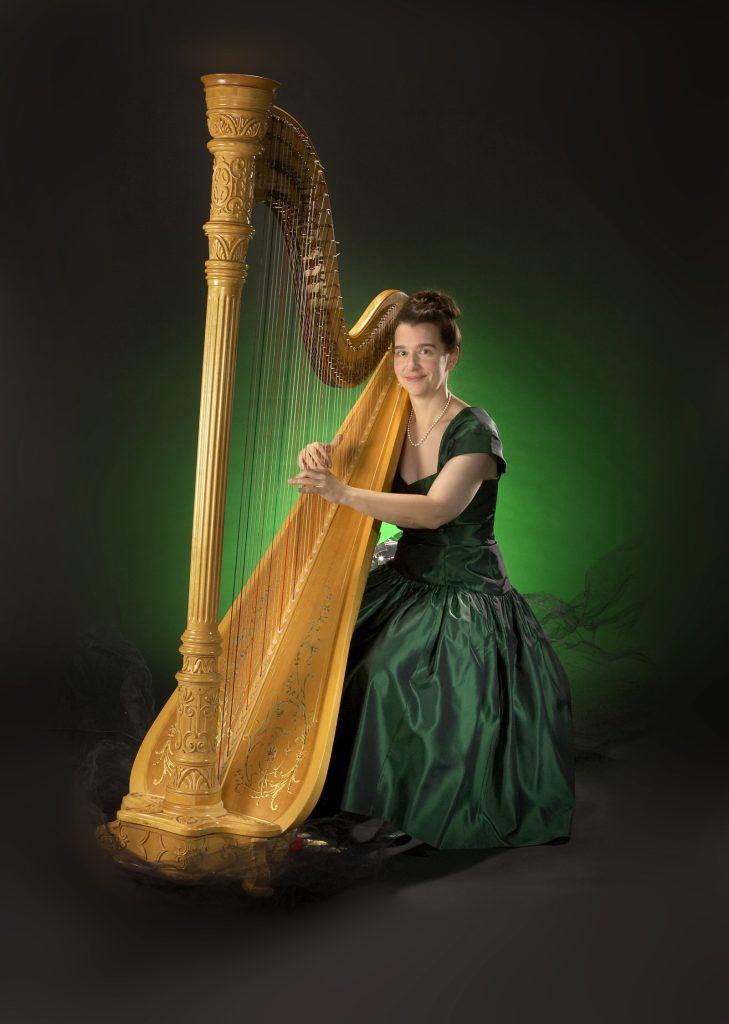Adrienne the Calgary Harpist posing with her classical harp