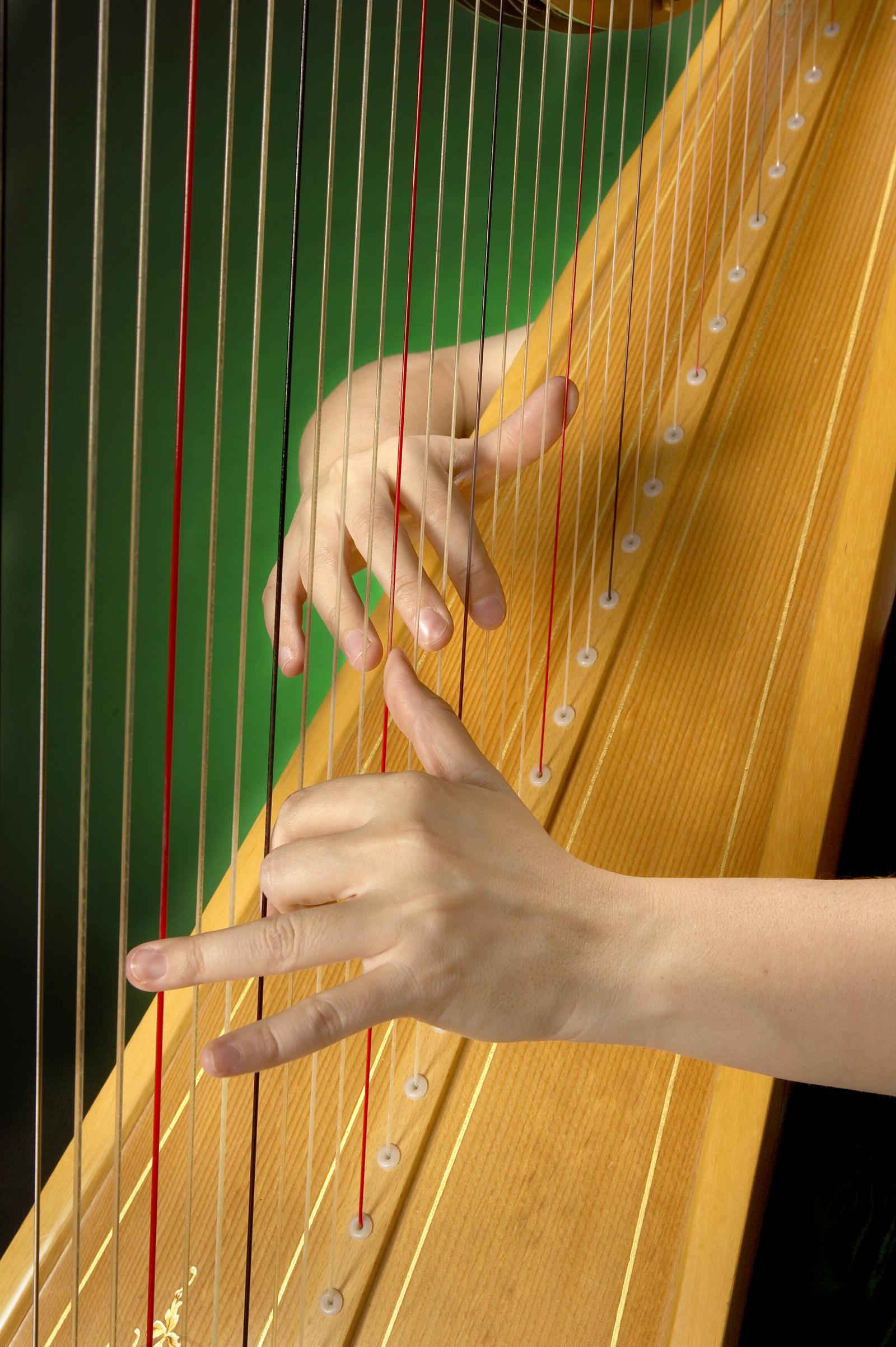 fingers playing a classical harp