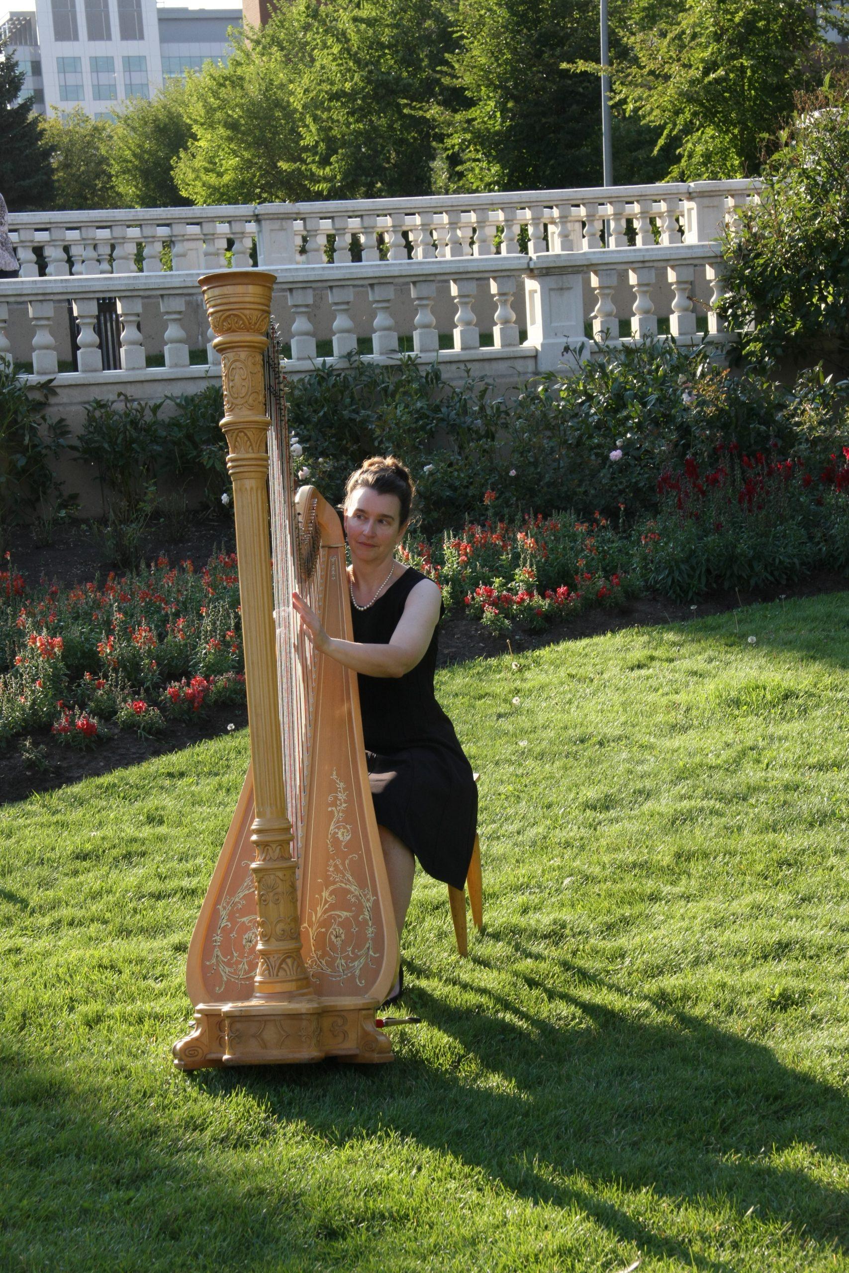 Calgary Harpist, Adrienne playing classical harp outside in Calgary