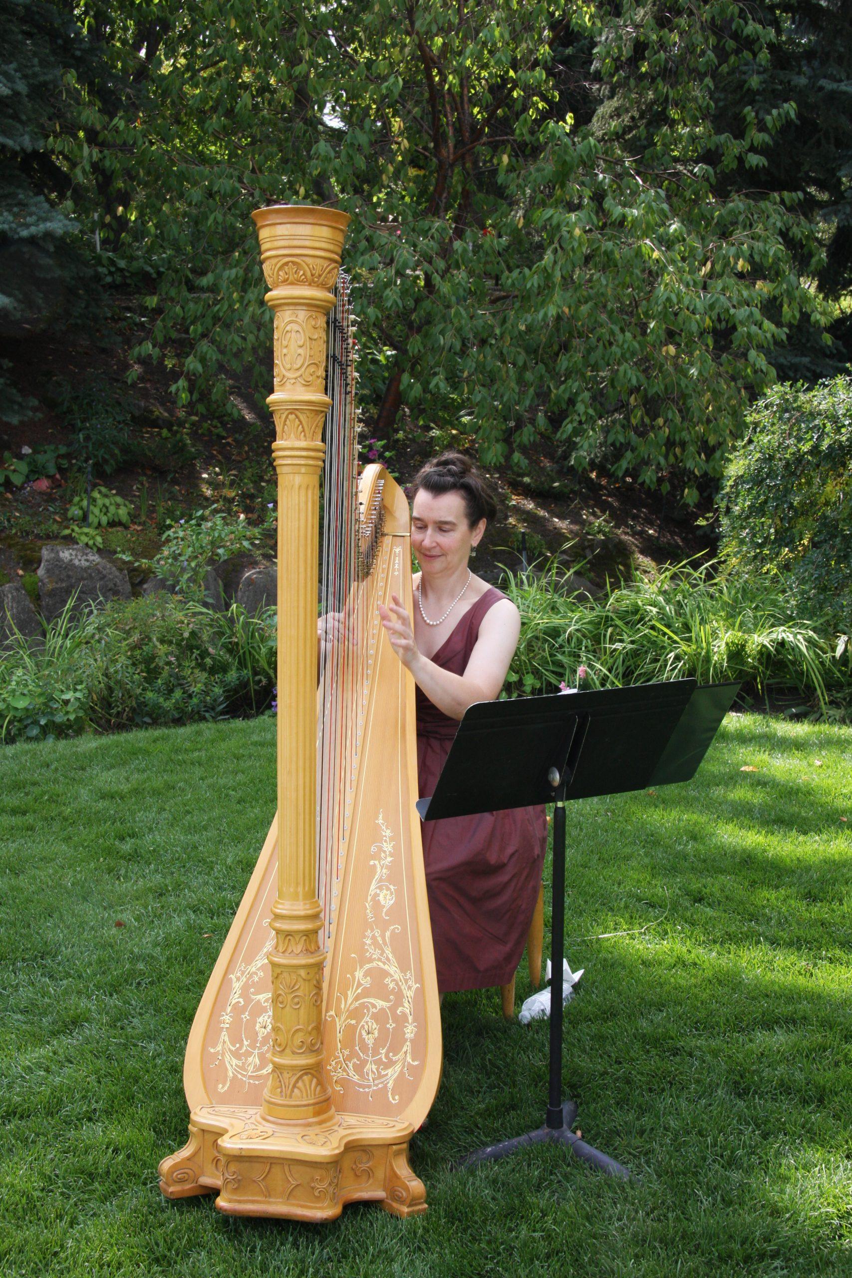 Adrienne, Calgary harpist playing classical harp outside