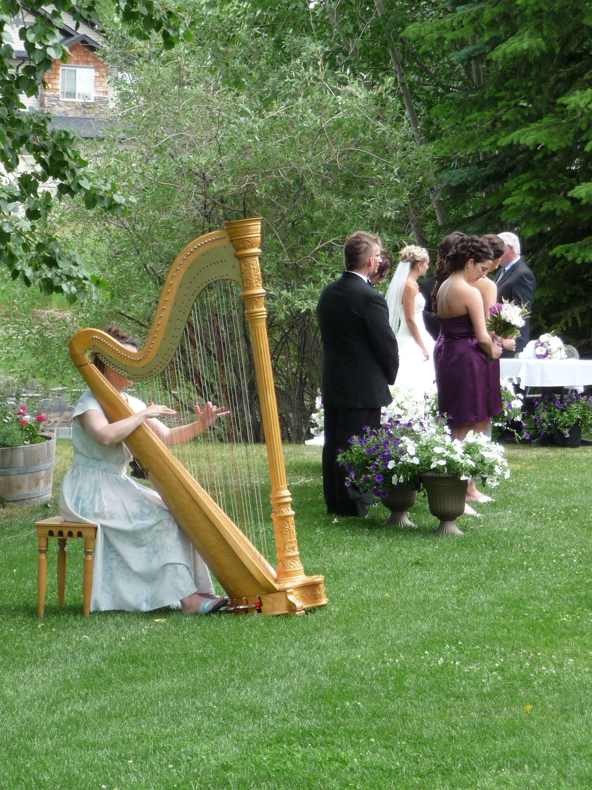 Adrienne, Calgary harpist playing the classical harp at a wedding outside